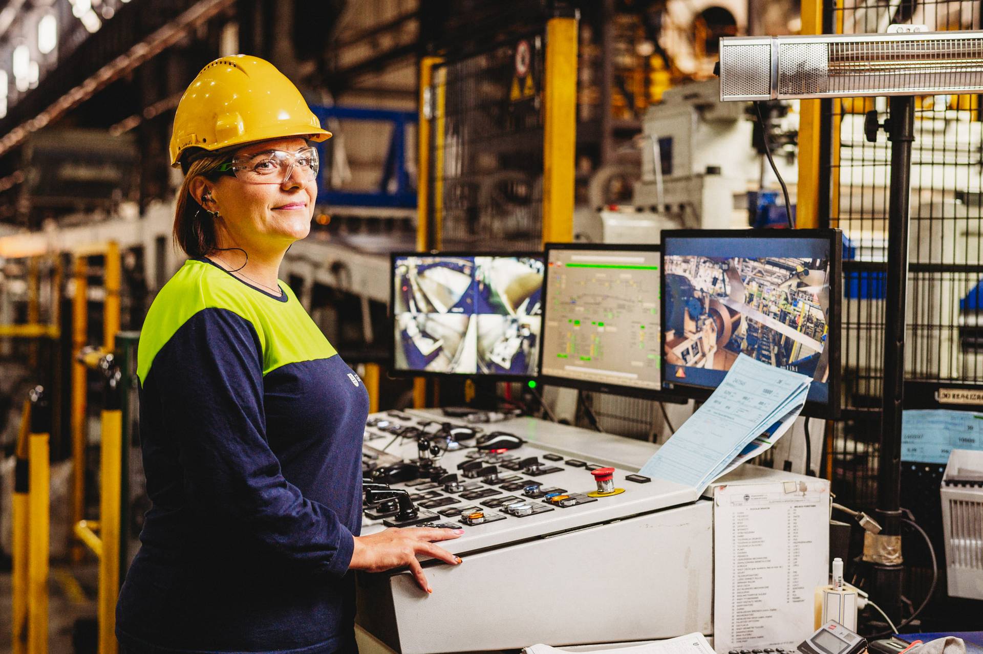 Employee operating a control panel.